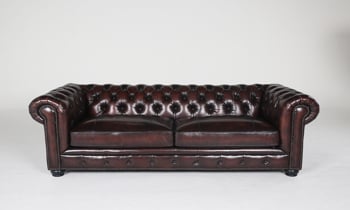 Timeless chesterfield brown leather armchair.