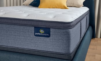 Hybrid mattress with a plush pillow top provides pressure point relief.